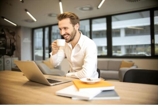 About Us 5 a happy man holding a cup of coffee